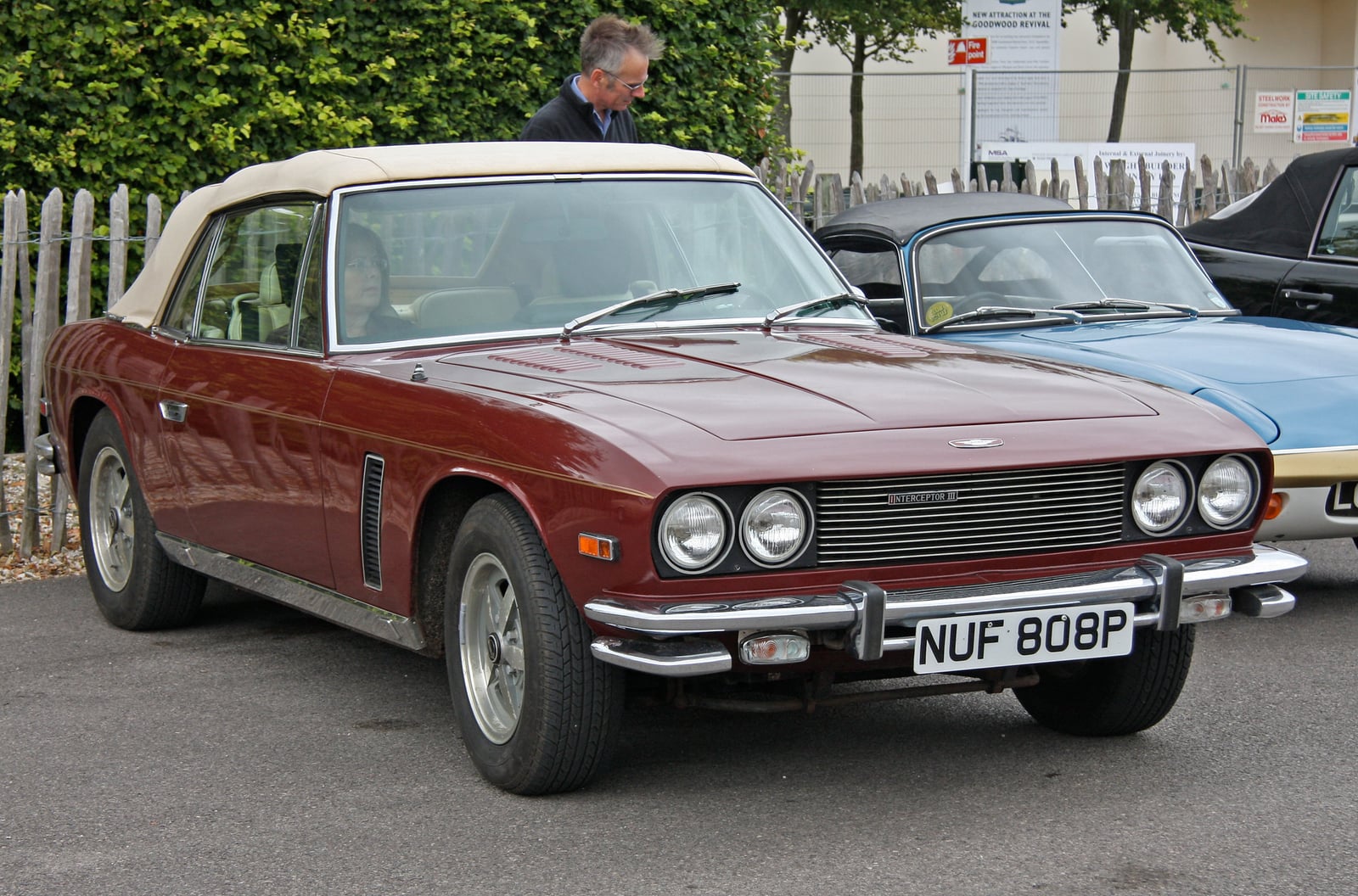 A dark red Jensen Interceptor III at a show, front three-quarter view