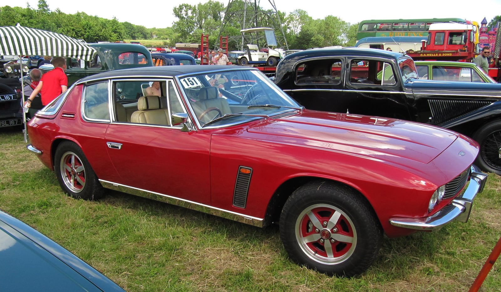 A red Jensen Interceptor III at a classic rally