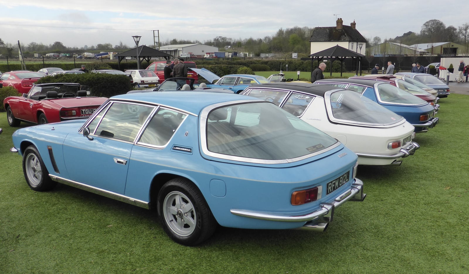 A line-up of several Jensen Interceptors at a show