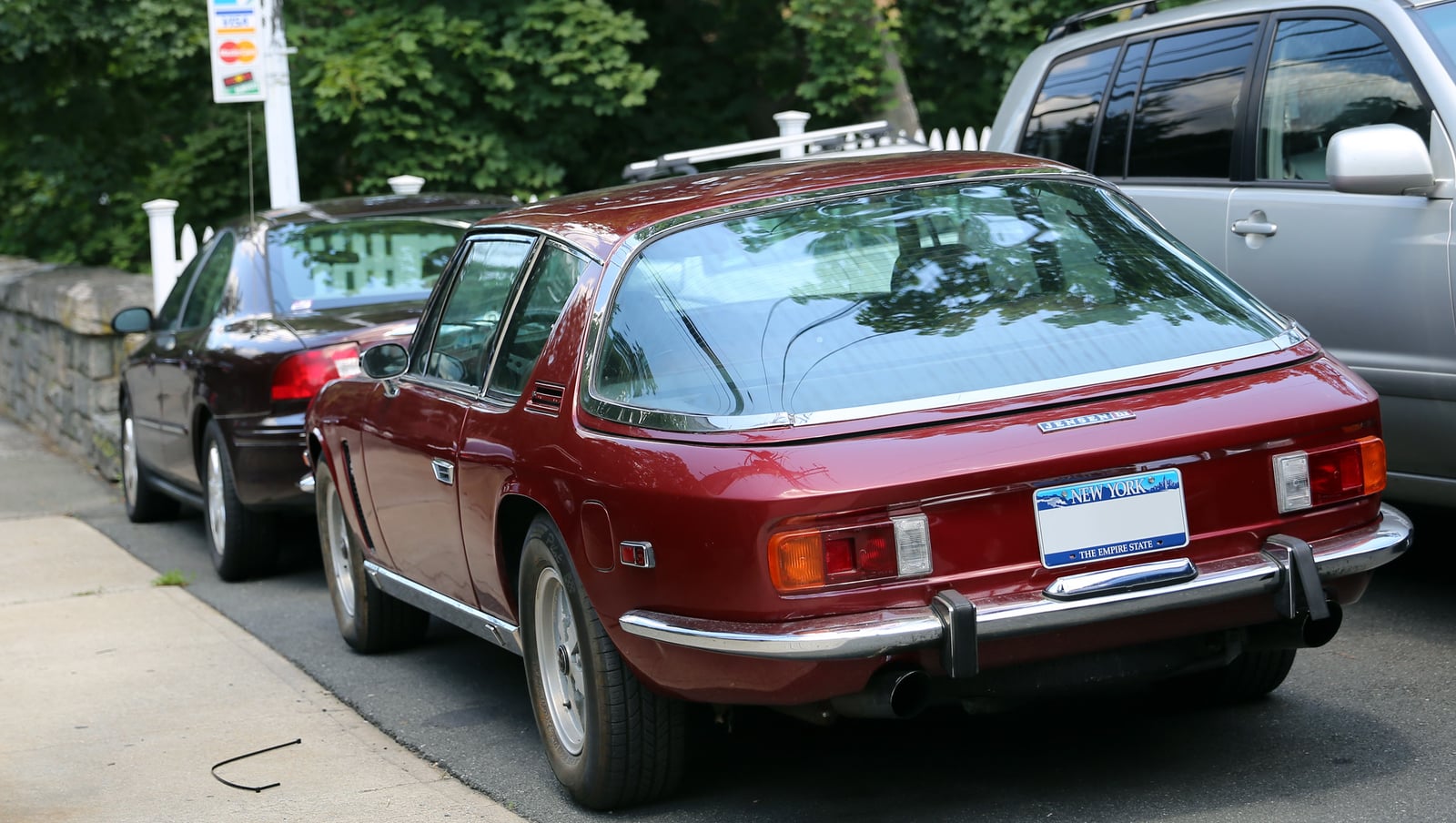 A dark red Jensen Interceptor Mark III, front three-quarter view