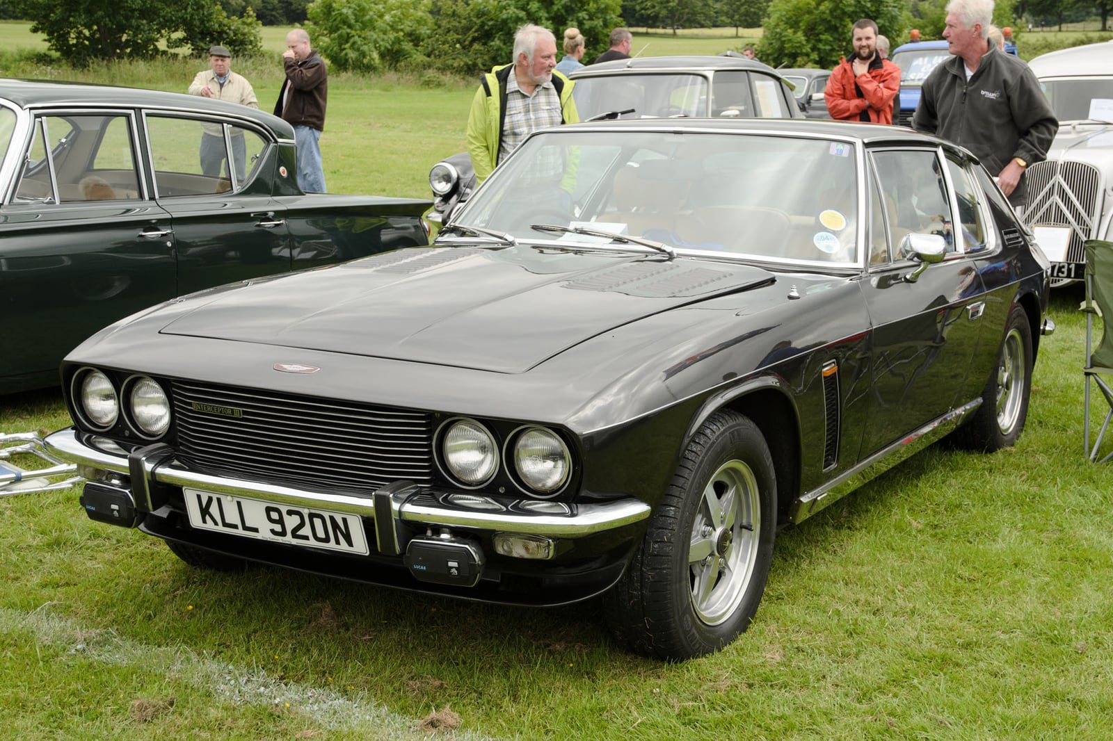 A dark blue Jensen Interceptor Mk III at a show with onlookers