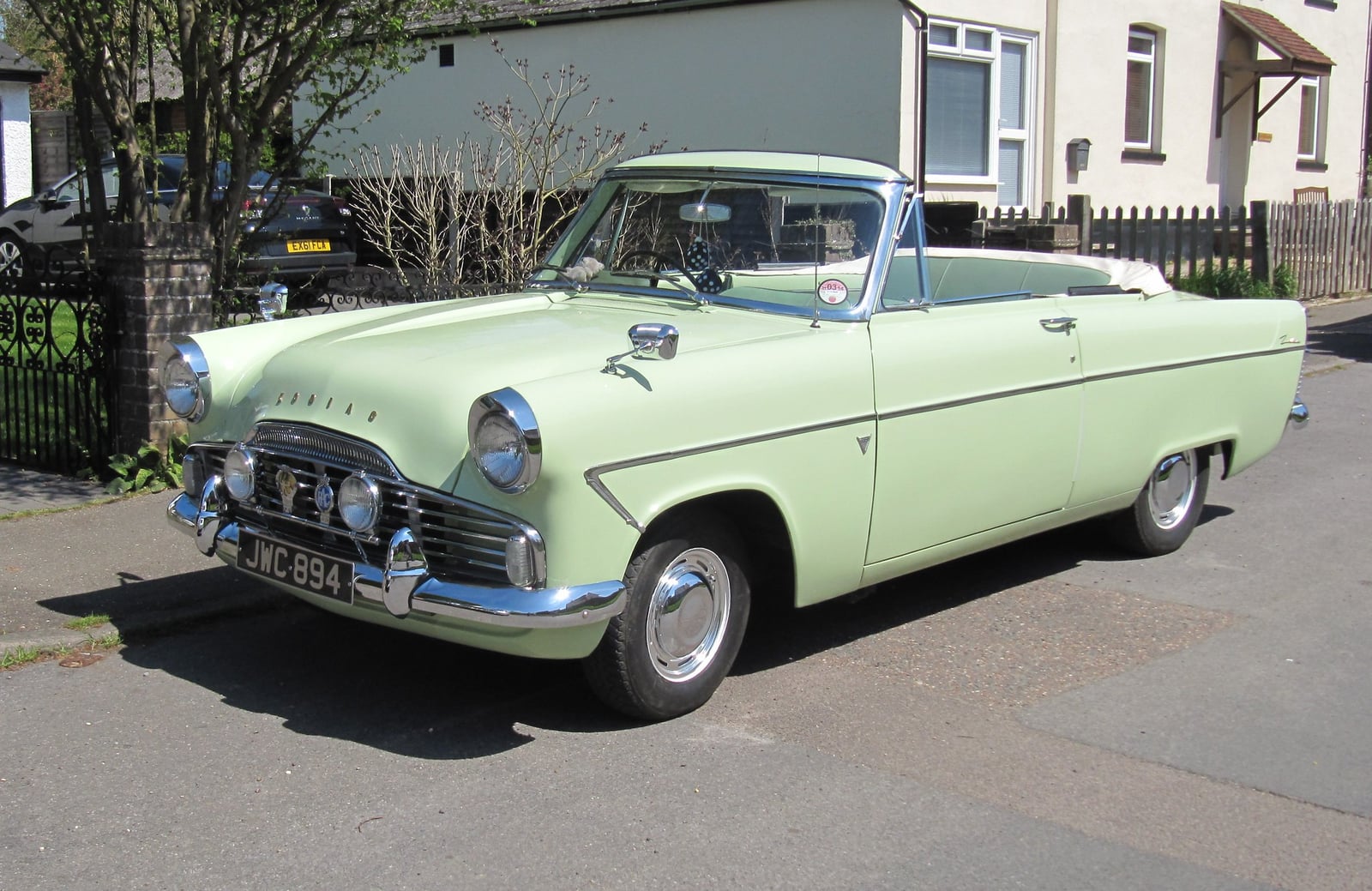 A pale green Ford Zodiac Mk2 convertible with the top down, front three-quarter view