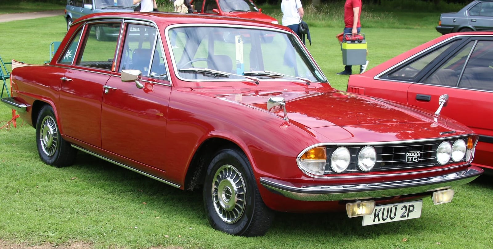 A red Triumph 2000 TC on grass at a classic car show, front three-quarter view, UK registration KUU 2P