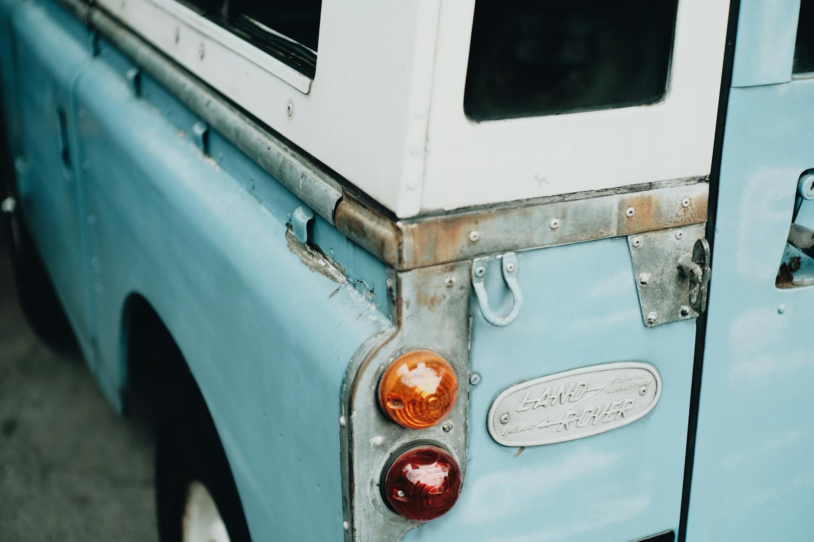 The cast LAND ROVER ENGLAND badge on the aluminium rear panel of a Series