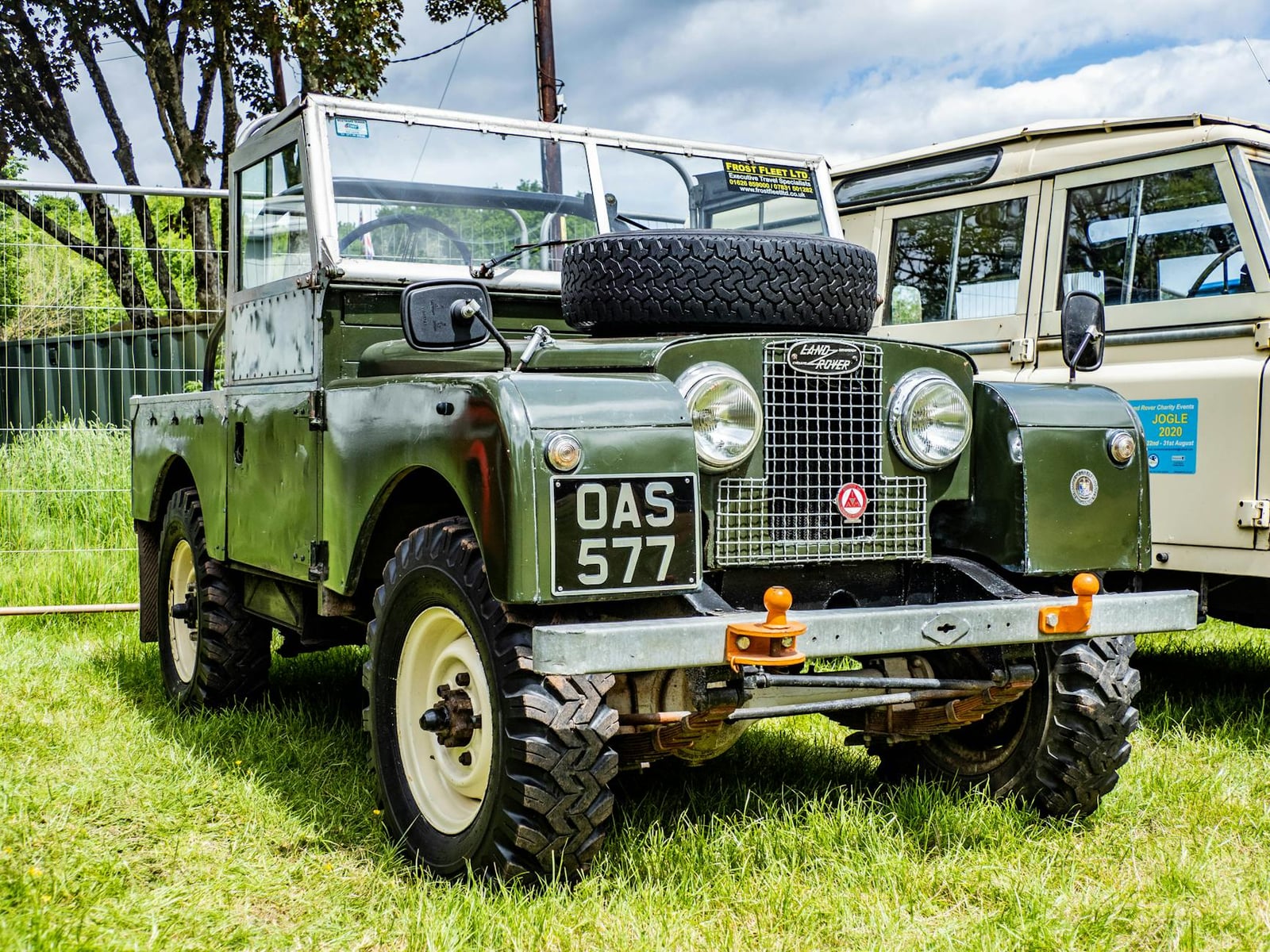 A blue Land Rover Series I at a classic vehicle show