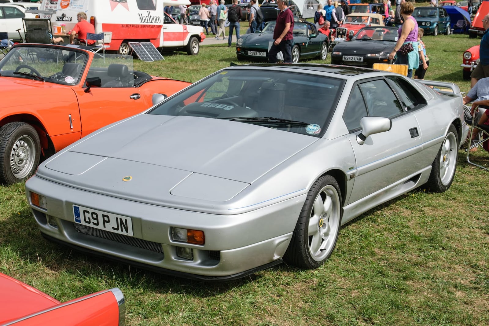 A silver 1989 Lotus Esprit X180 with a UK registration on a show field