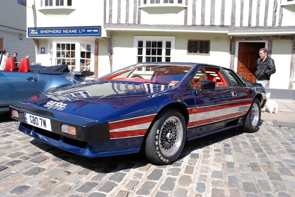A Lotus Esprit Turbo in Union Jack livery parked on cobbles, front three-quarter view, UK registration CBO 7W