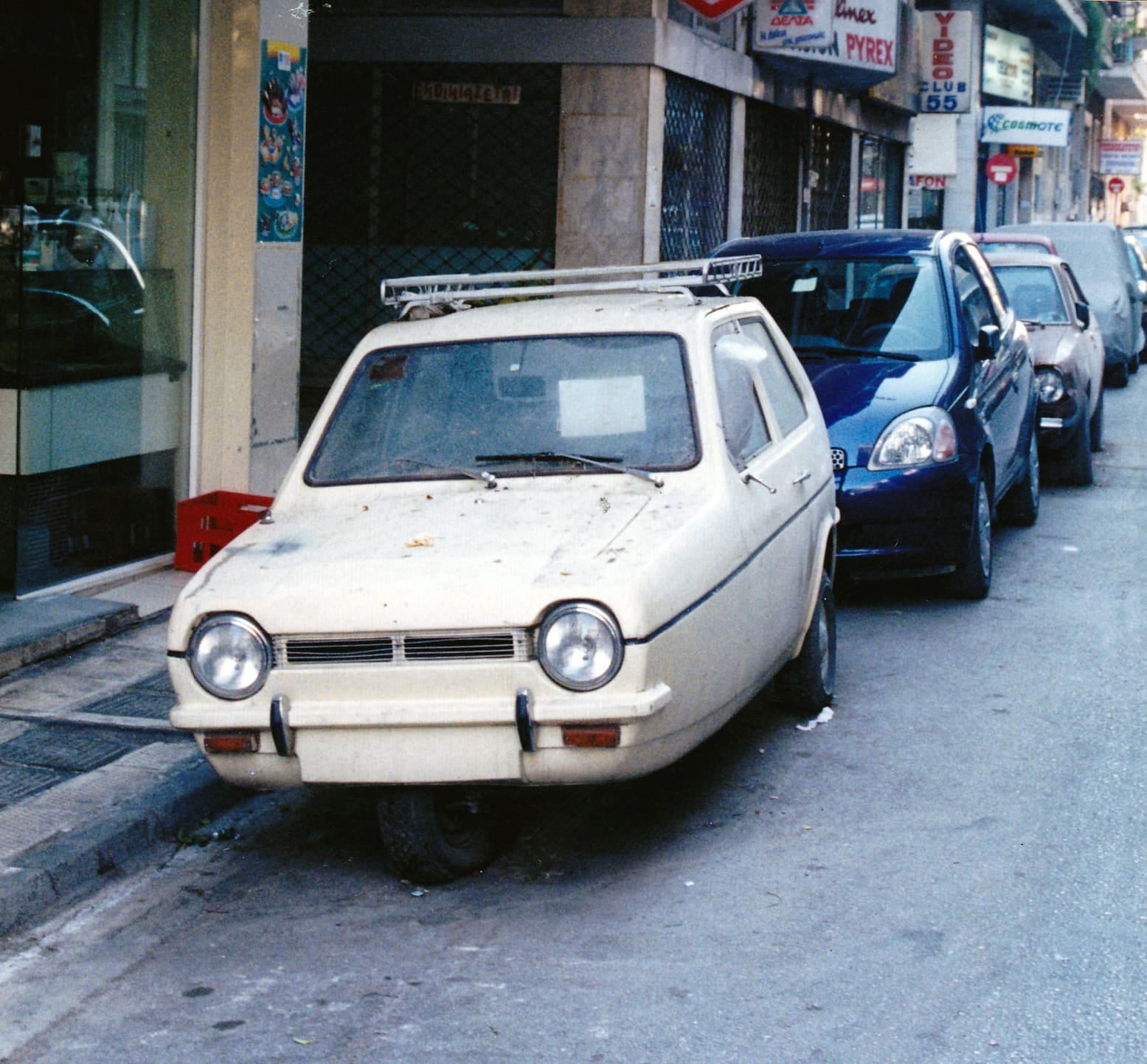 A white MEBEA-built Reliant Robin on a street in Athens, front view