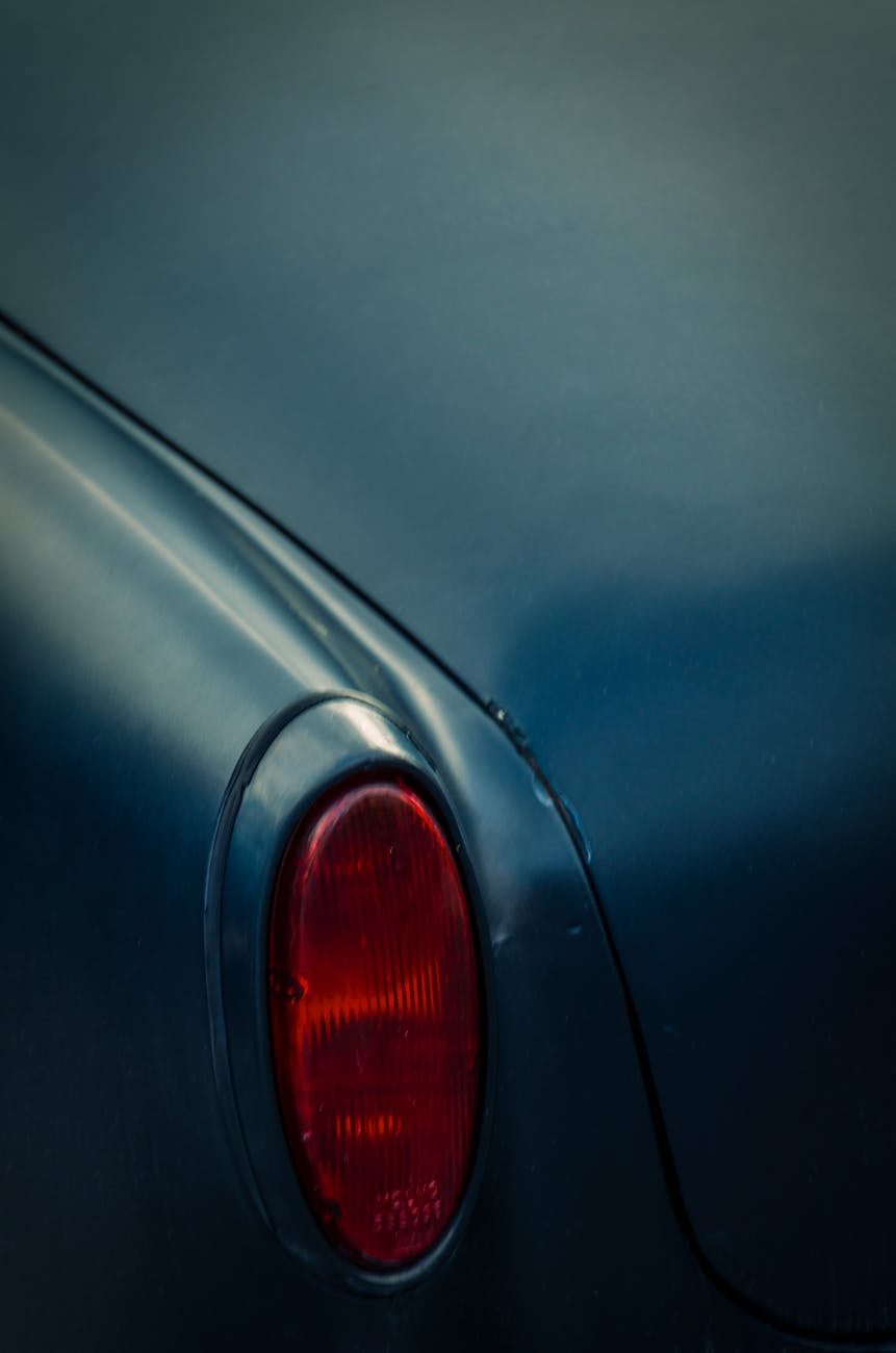 The rear of an orange MG Midget