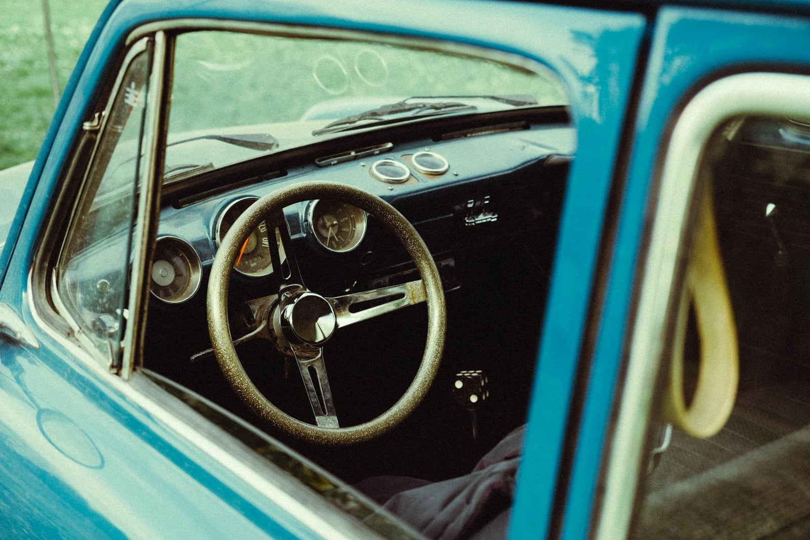 The cockpit of an MG Midget, showing the steering wheel and dashboard