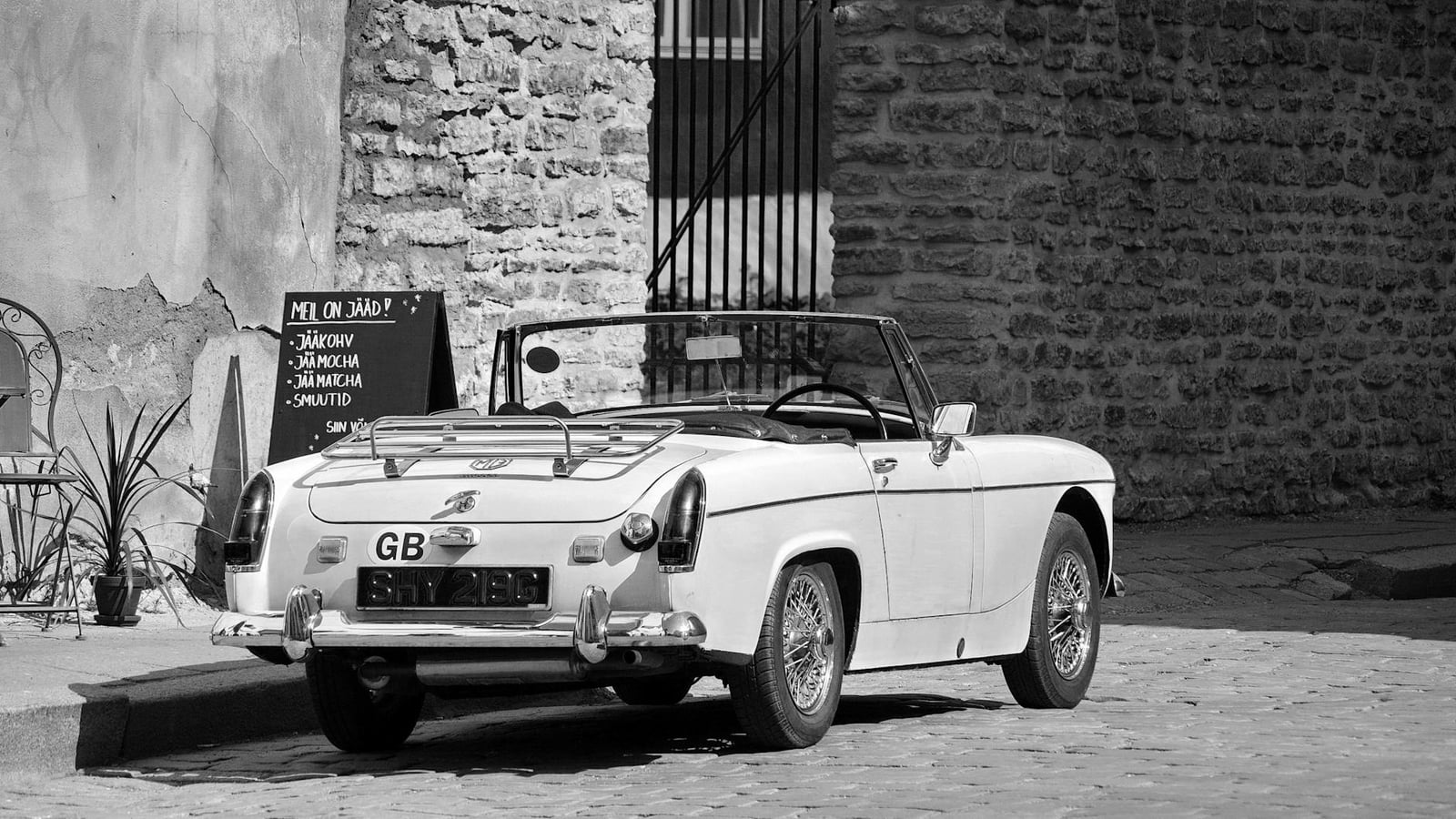A white MG Midget on wire wheels, three-quarter view