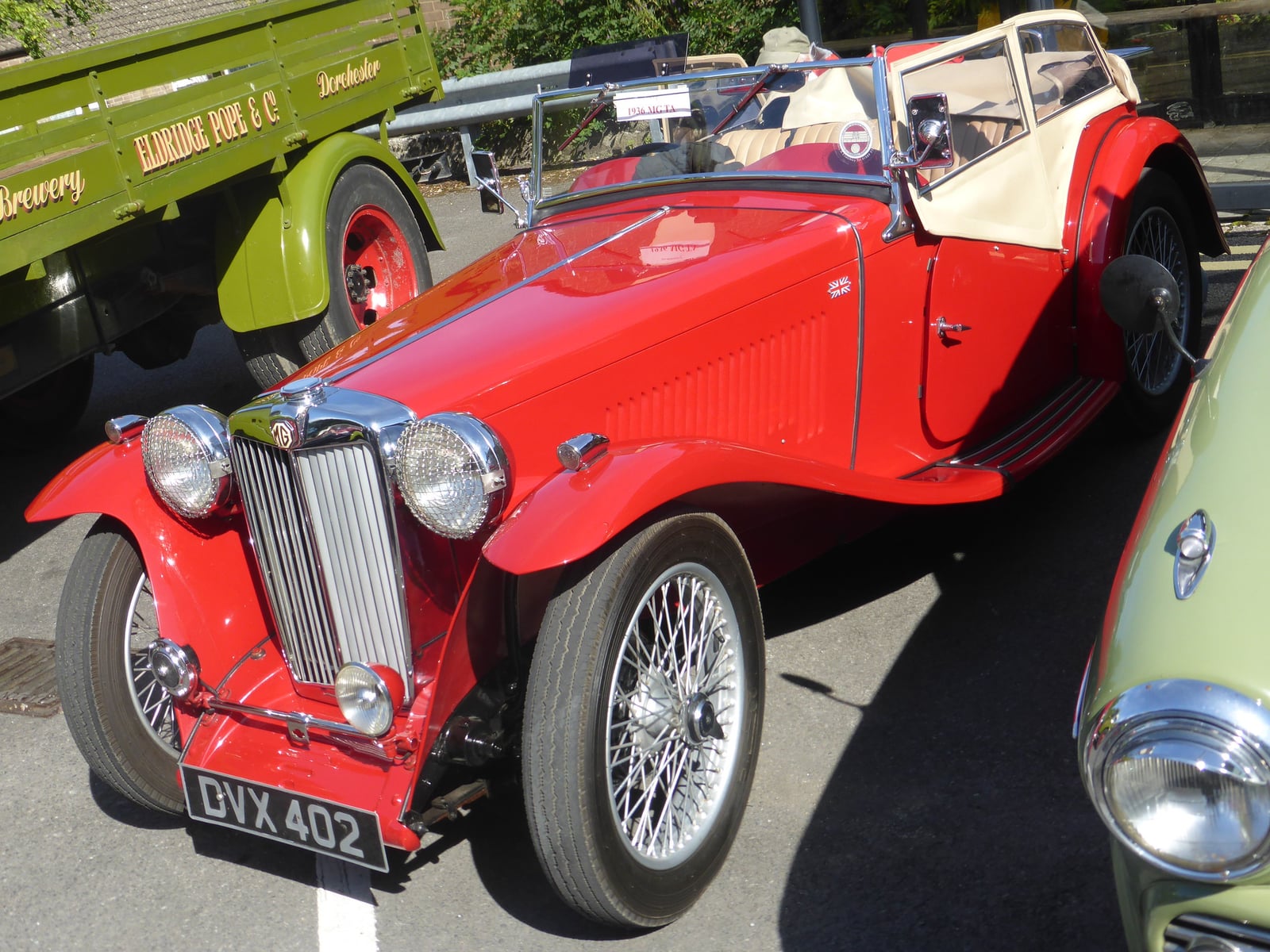 A red MG TA of 1936 at a show, front three-quarter view