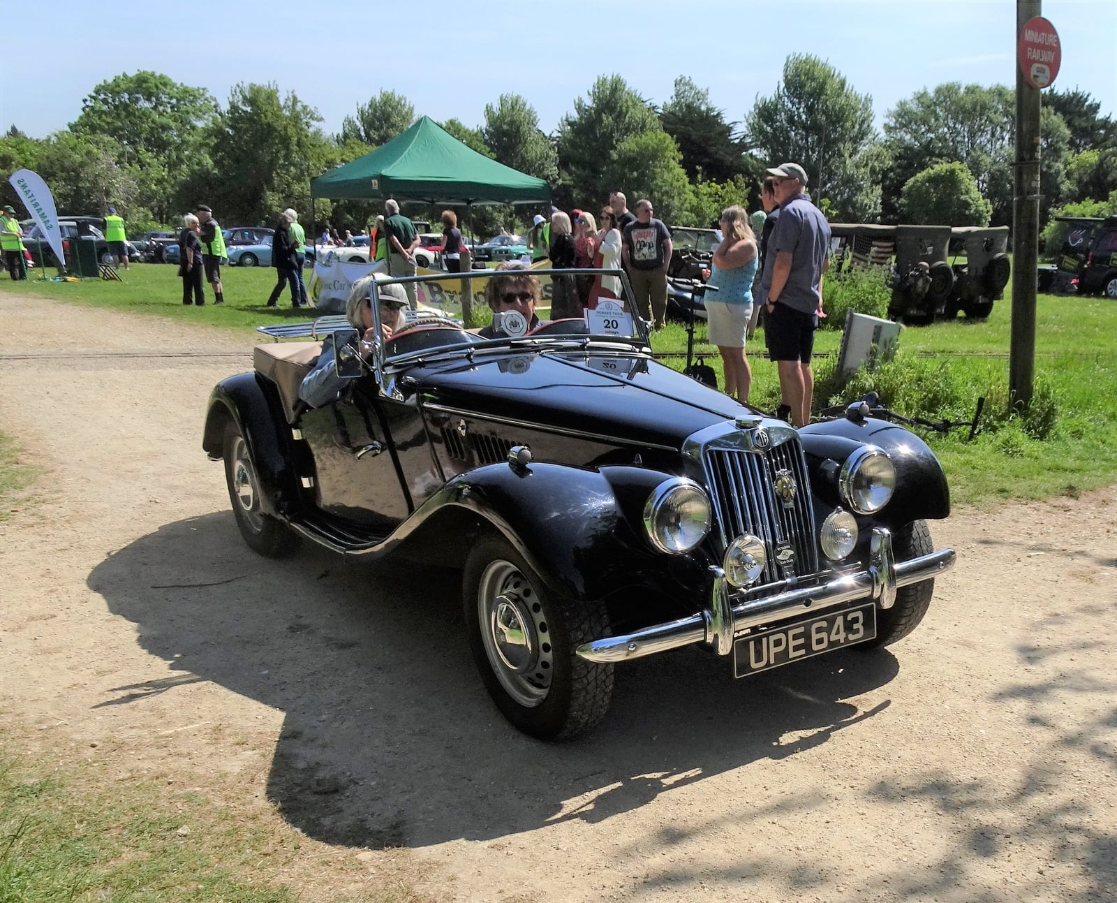 A black MG TF roadster, front three-quarter view at a classic car show, UK registration UPE 643