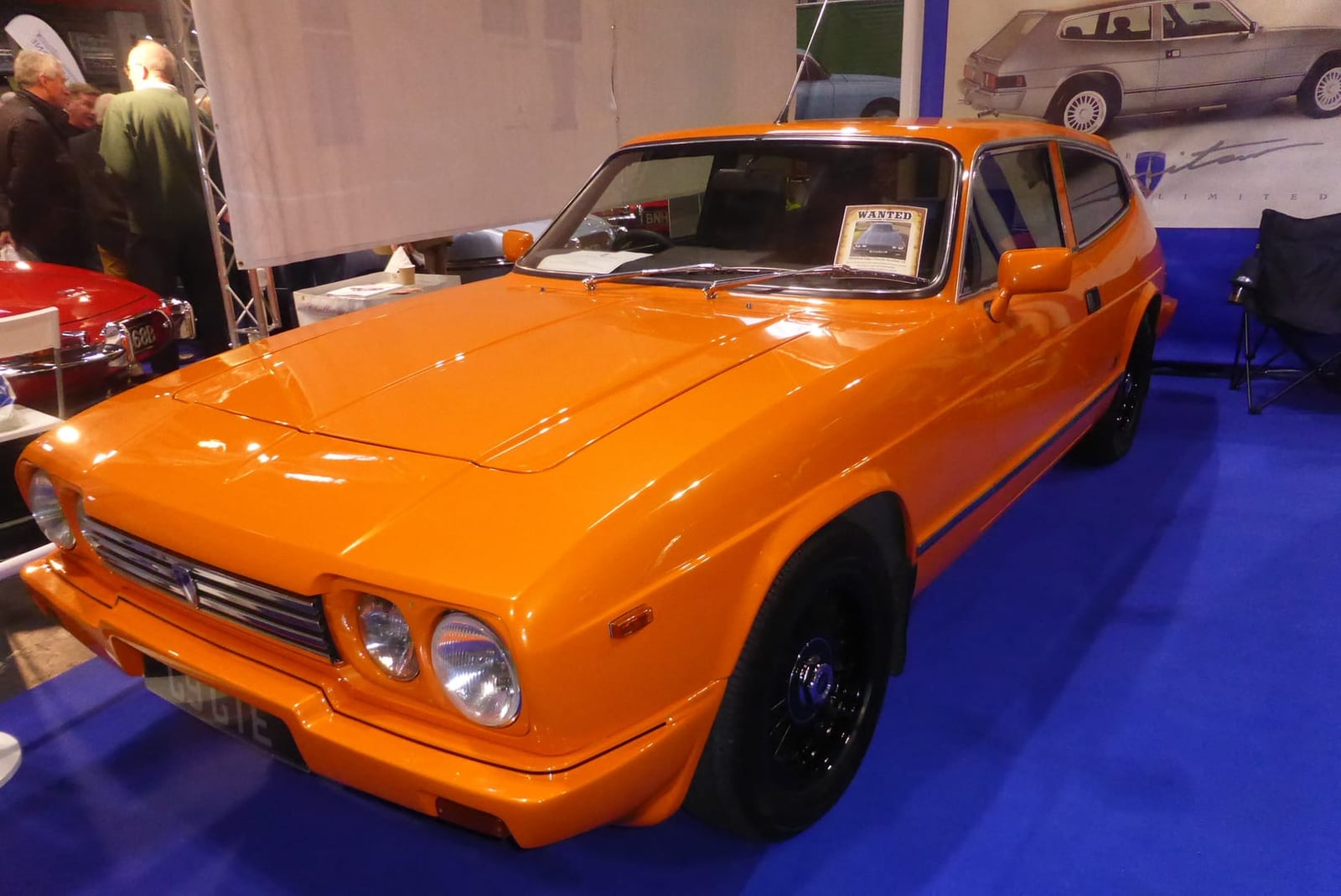 An orange 1989 Middlebridge Scimitar GTE displayed at an indoor show