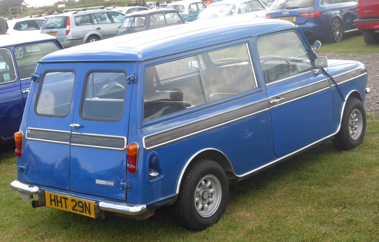 A blue Mini Clubman Estate at a show, side view
