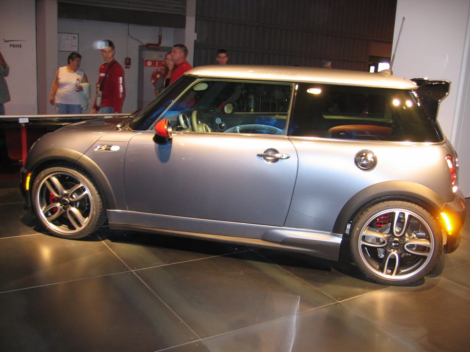 A Thunder Blue MINI Cooper S Works GP with a silver roof and rear spoiler displayed at the 2006 Paris motor show