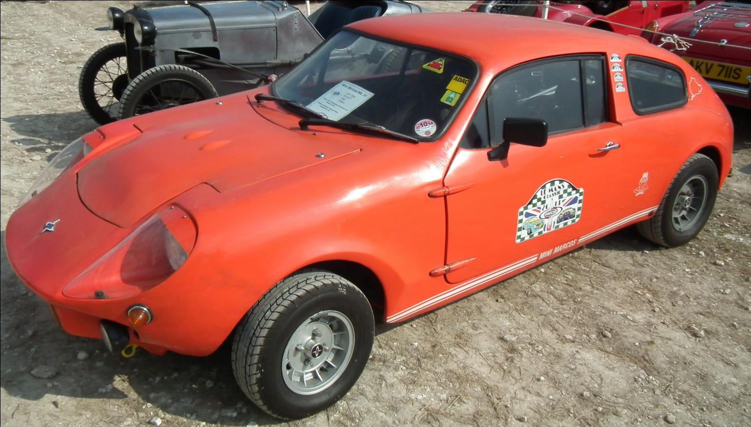A red Mini Marcos being driven hard at a hillclimb event