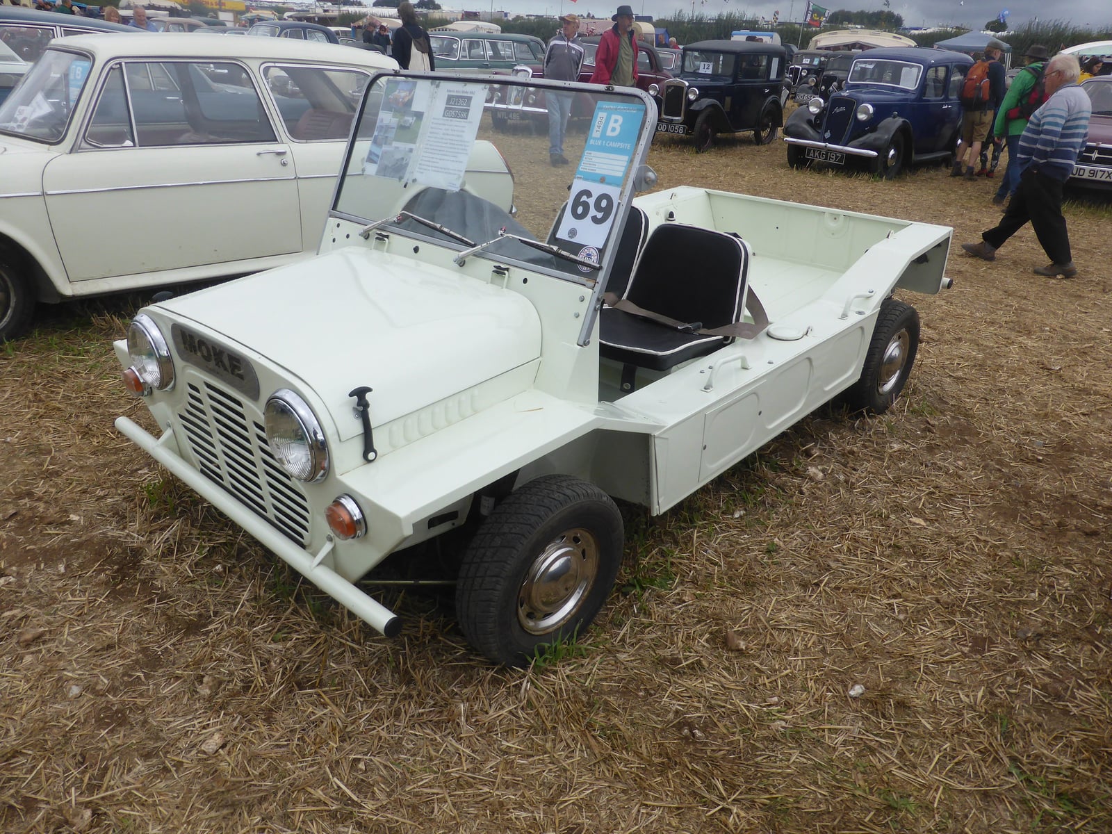 A white Mini Moke in plain military-style trim at a show