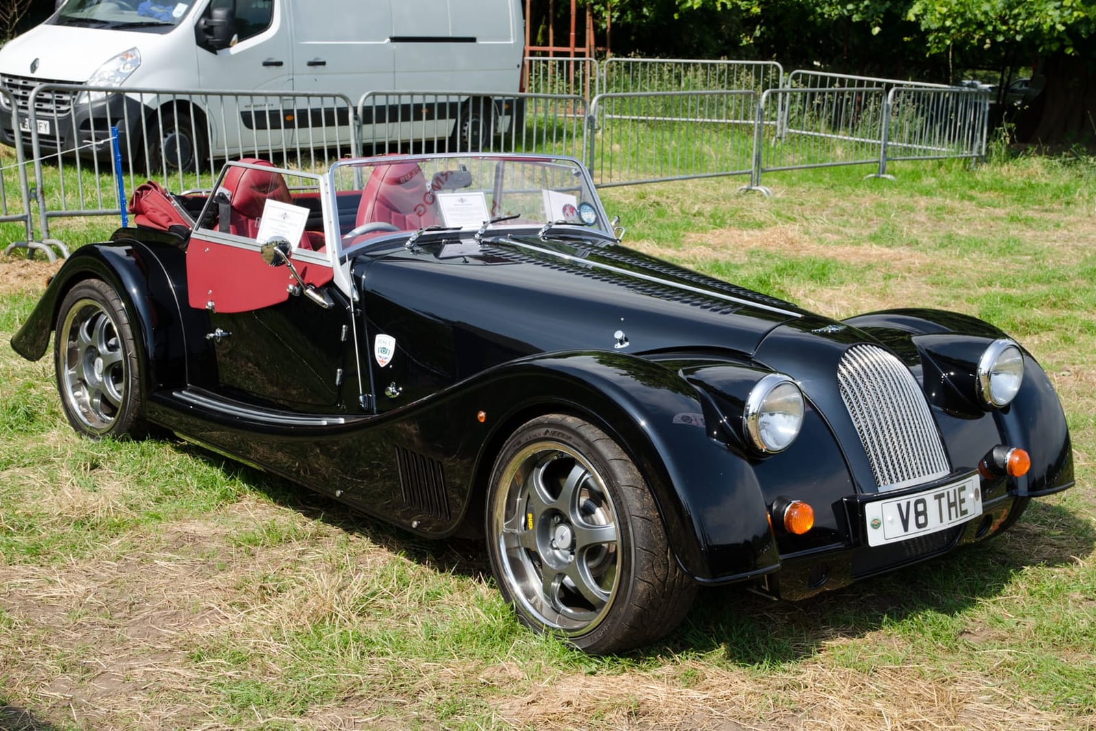 A black 2013 Morgan Plus 8 4.8 with BMW power at an outdoor show