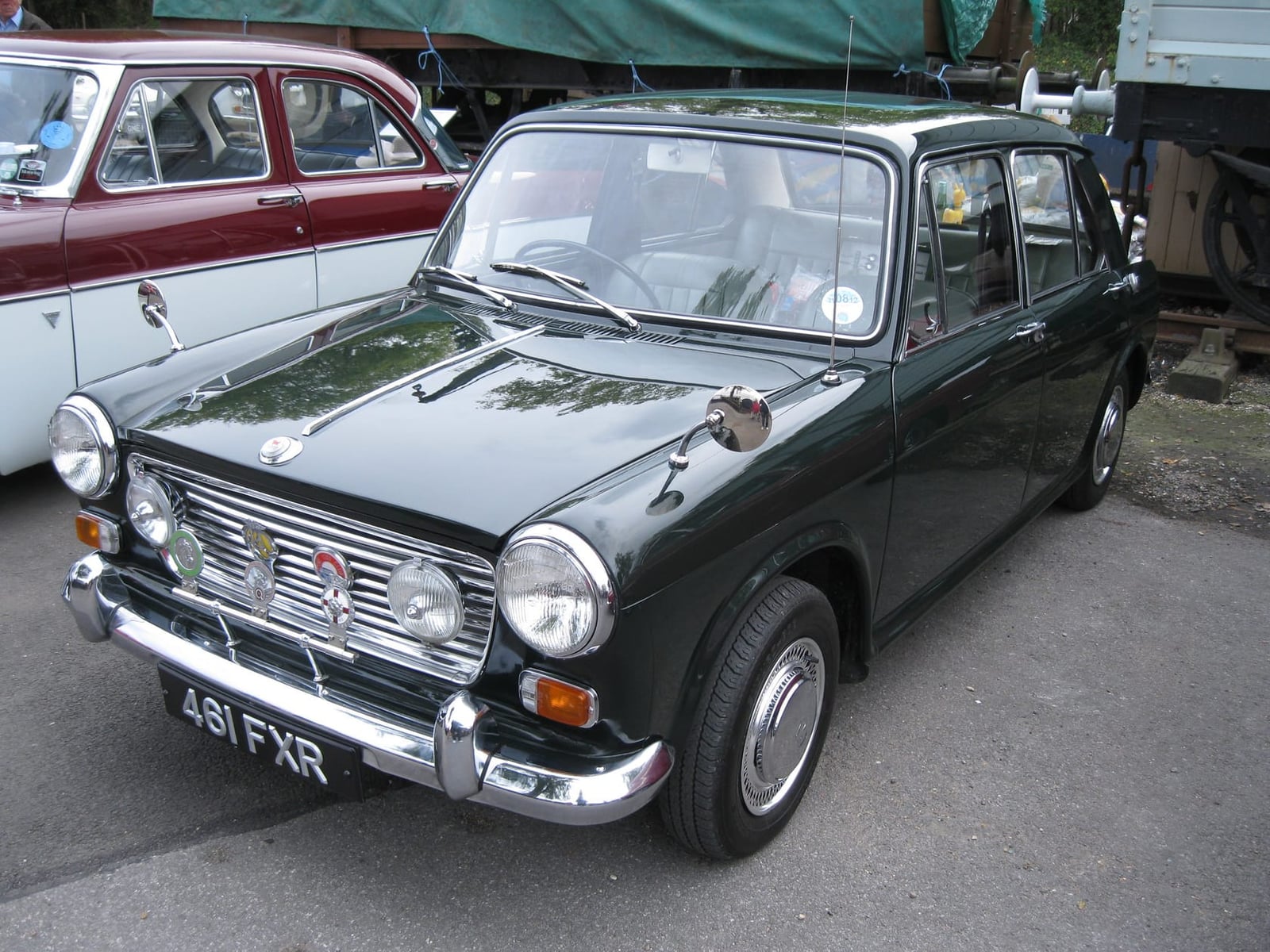 A green Morris 1100 at a classic vehicle show, front three-quarter view, UK registration 481 FXR