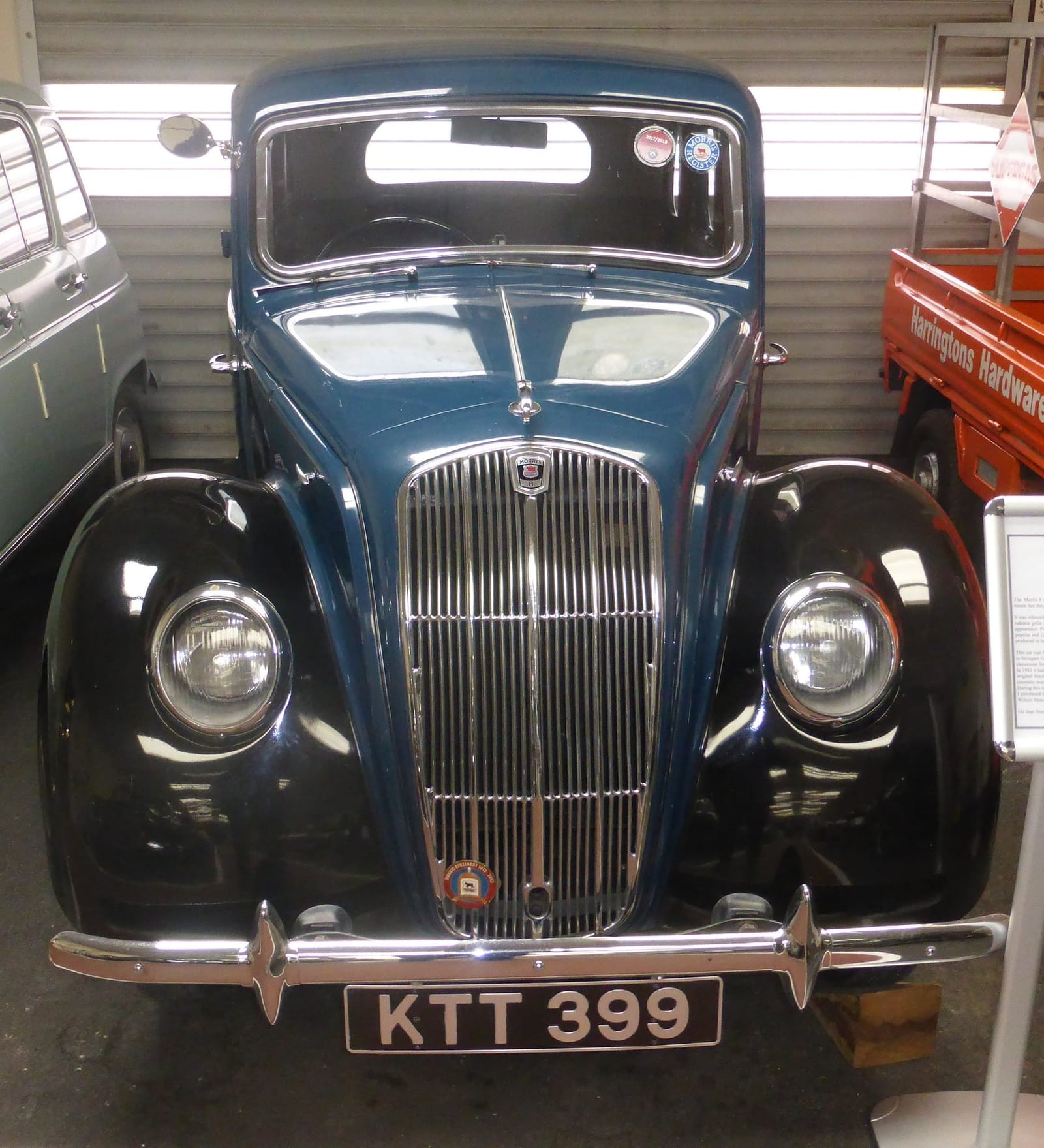 The front of a dark 1947 Morris Eight Series E showing its waterfall grille and faired-in headlamps, UK registration KTT 399