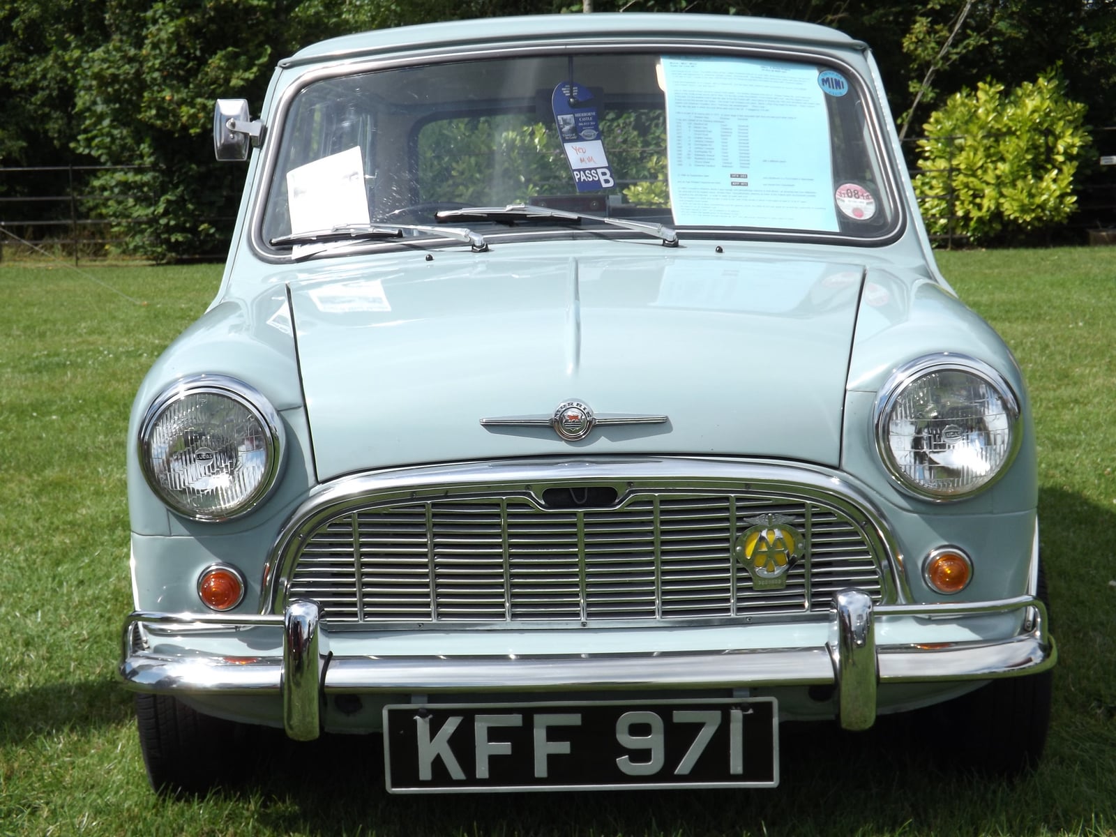A pale blue 1960 Morris Mini-Minor at a show, front view