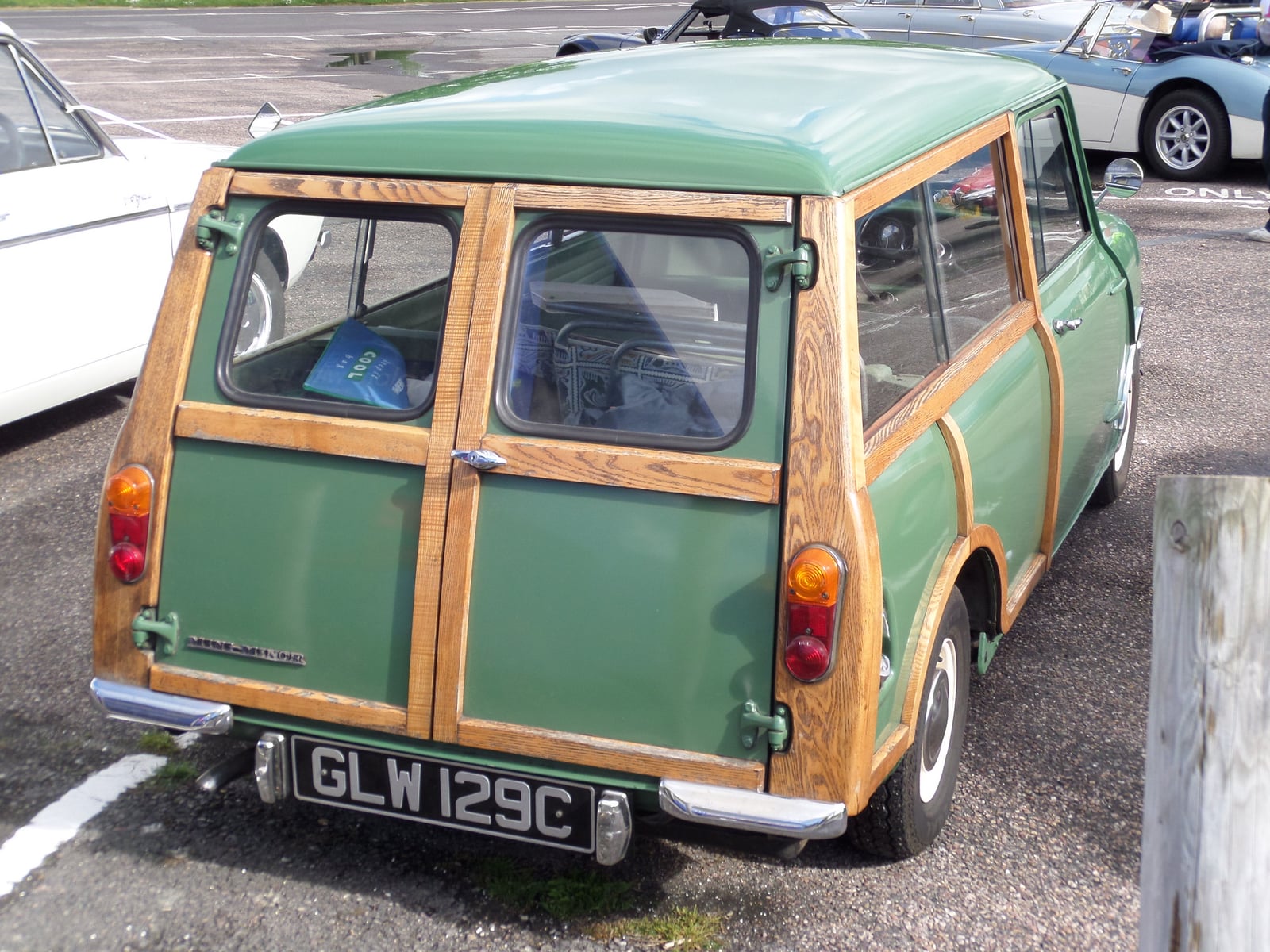 The rear of a green woody Morris Mini Traveller, showing the timber and twin doors