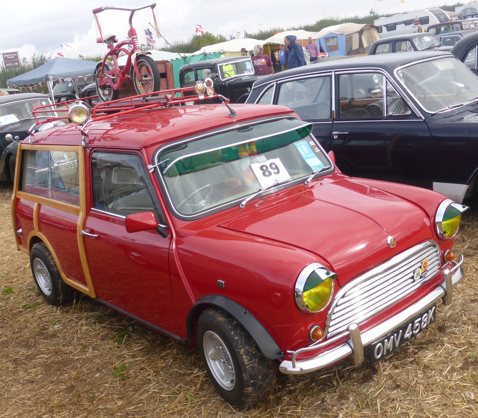 A red woody Mini Traveller estate with a roof rack, front three-quarter view