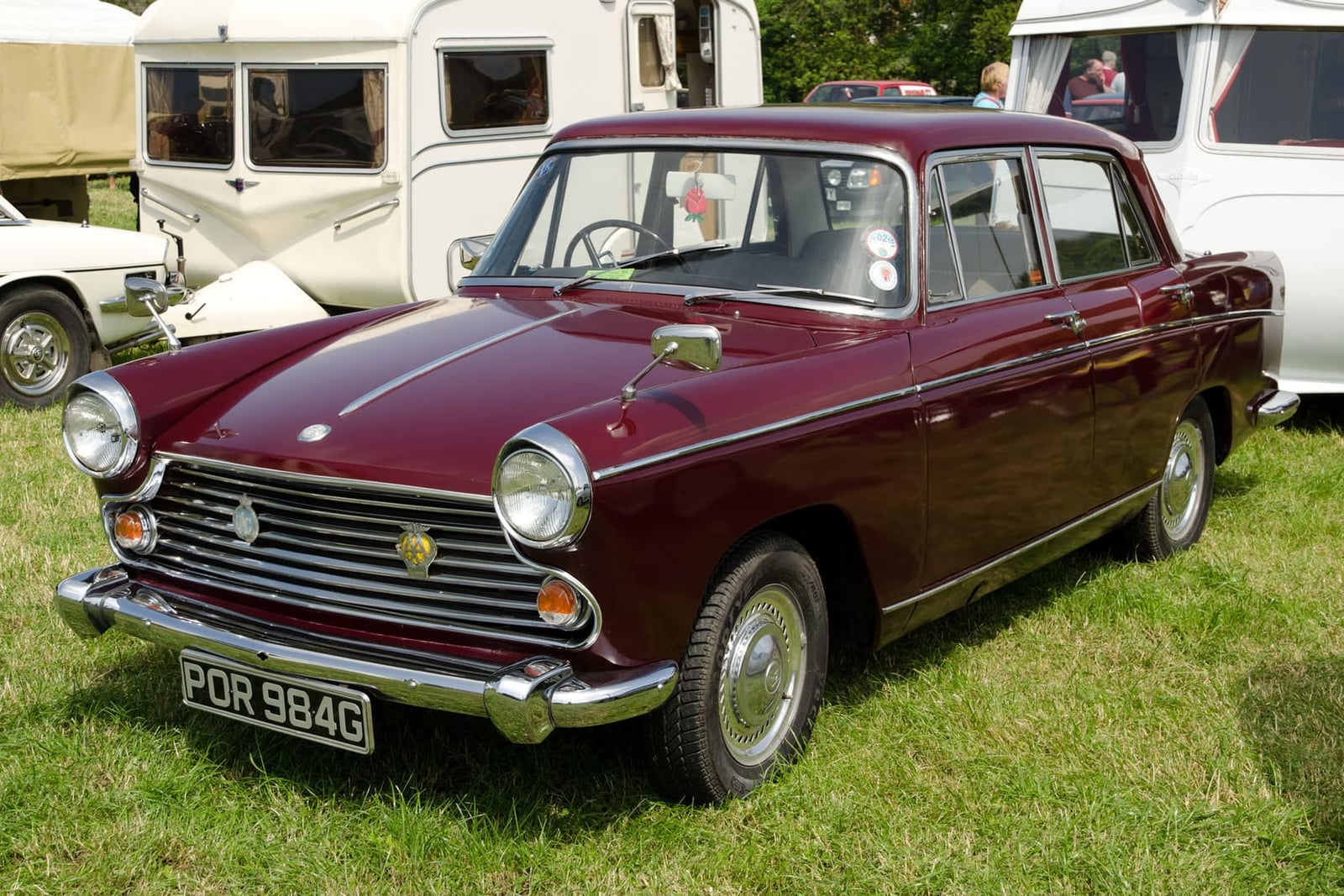 A maroon 1968 Morris Oxford Series VI saloon at a classic car show, front three-quarter view