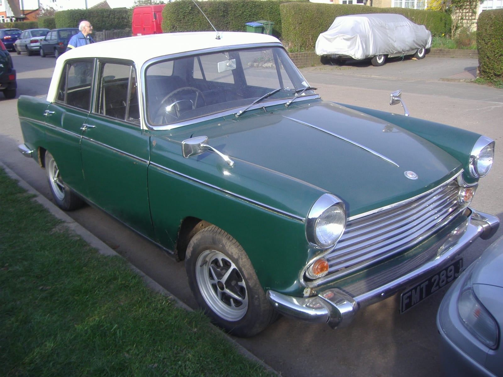 A green Morris Oxford Series VI parked at the kerb on a street, front three-quarter view, UK registration FMT 289J