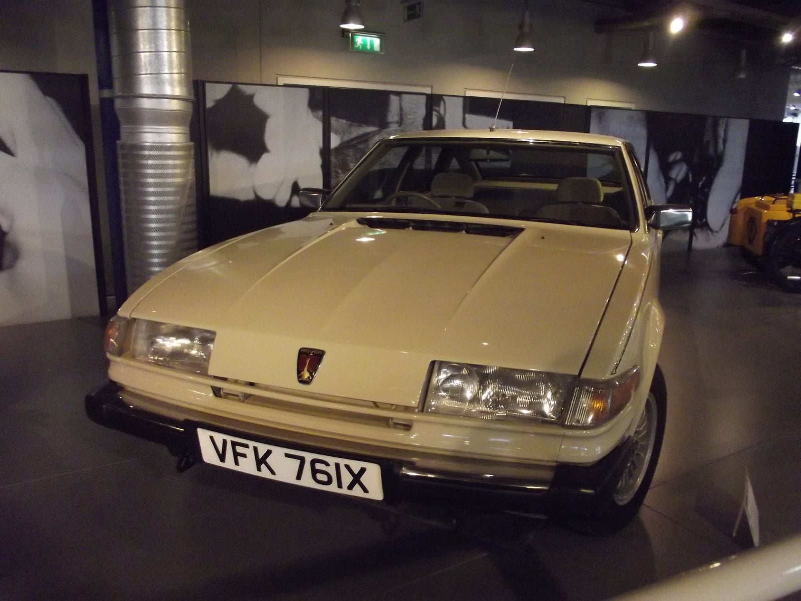 A cream Rover SD1 hatchback saloon, front three-quarter view, its wedge-shaped body shown indoors