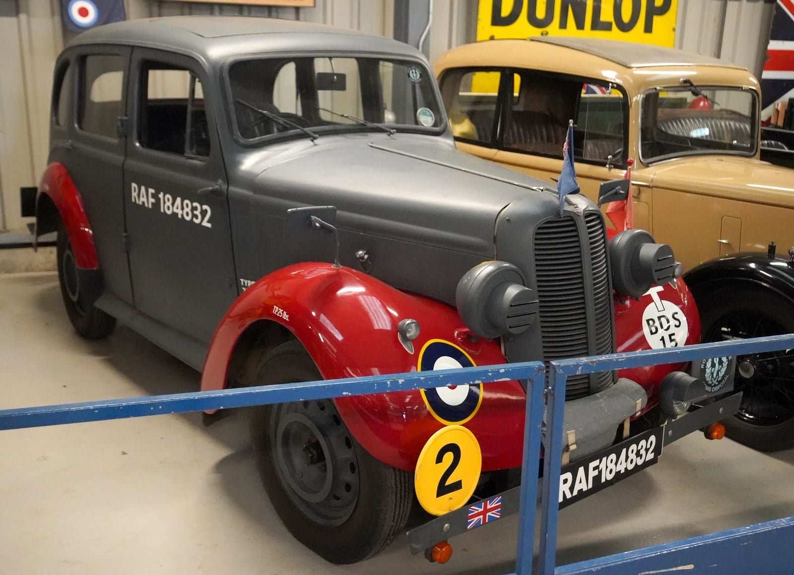 A 1938 Hillman Minx RAF staff car in wartime grey and red, displayed in a museum