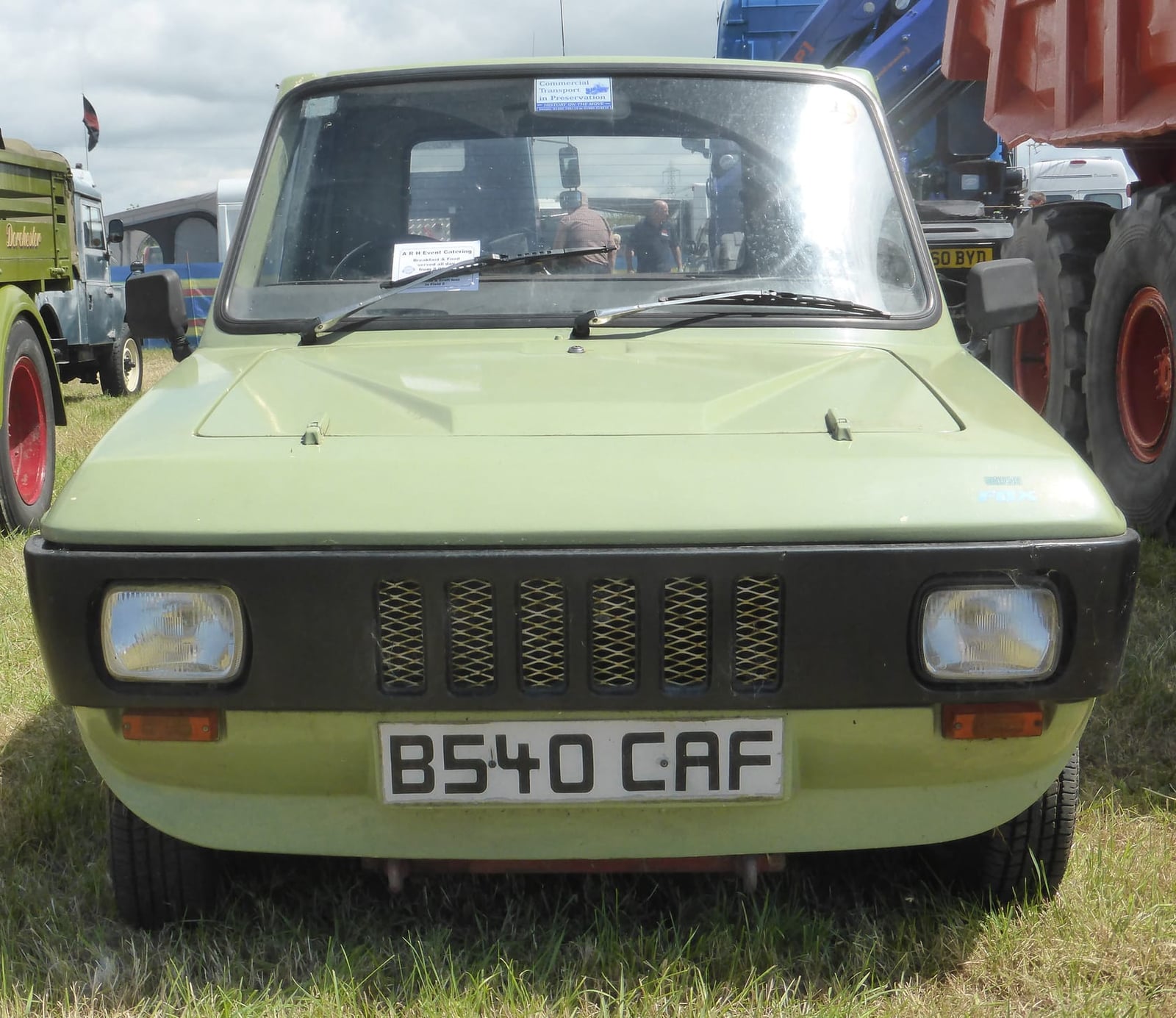 A pale green 1985 Reliant Fox pickup photographed head-on at a vehicle rally, UK registration B540 CAF