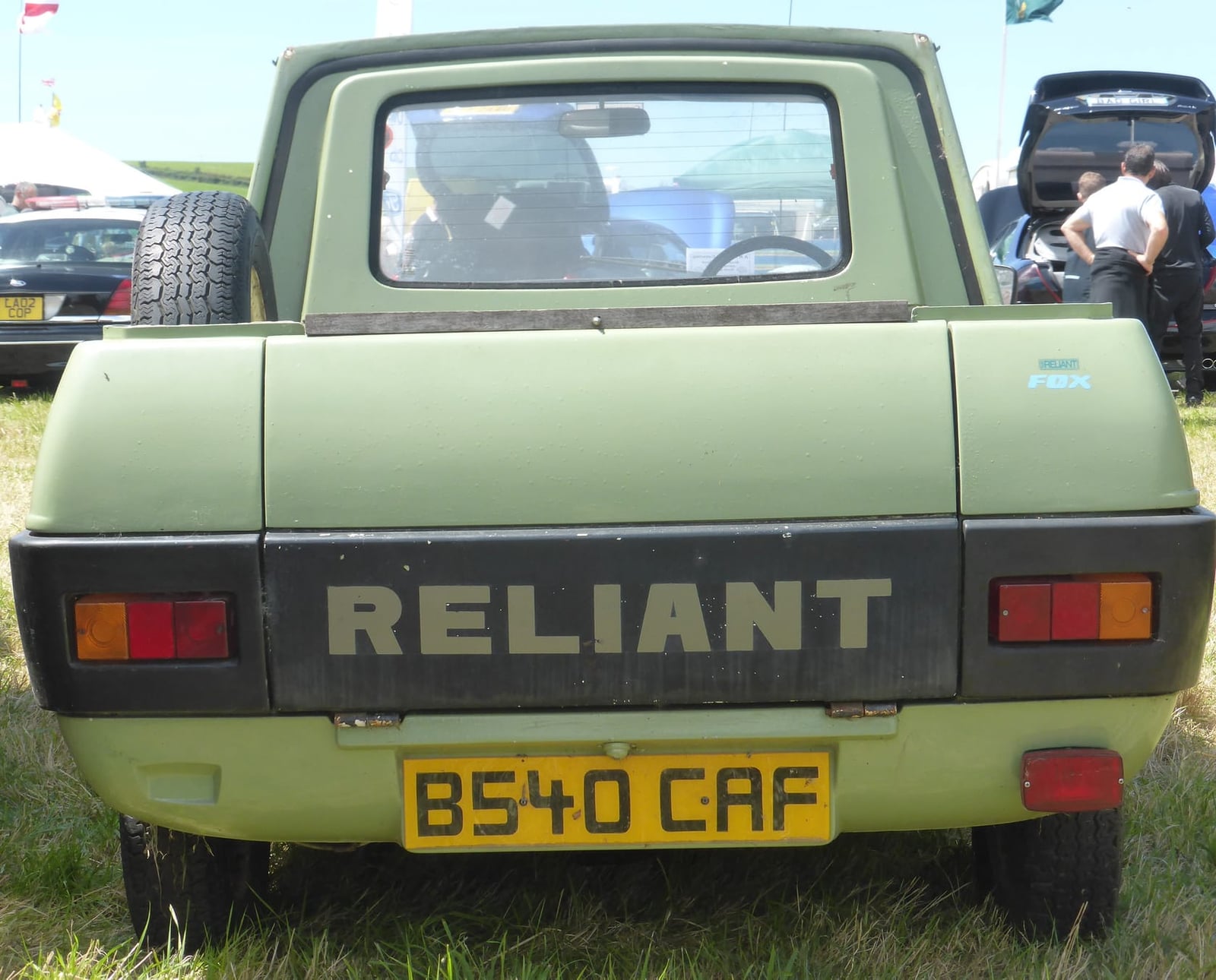The rear of a pale green Reliant Fox pickup showing the RELIANT tailgate lettering, UK registration B540 CAF
