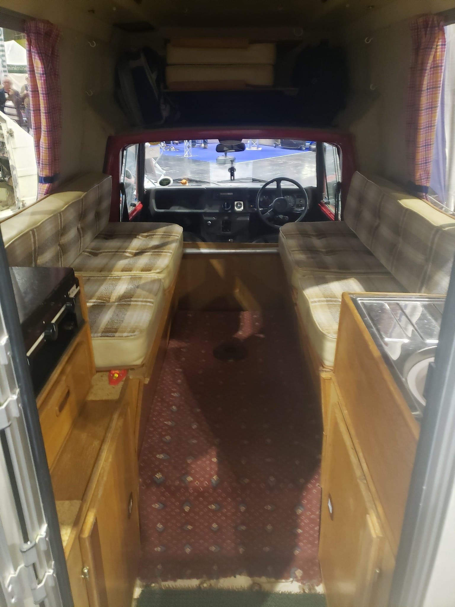 The interior of a Reliant Fox showing the simple dashboard, bench seat and load area behind