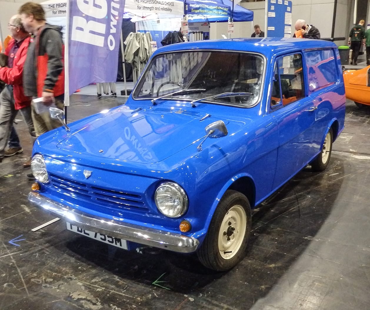 A blue Reliant Rebel van on a Reliant Owners Club stand at an indoor show