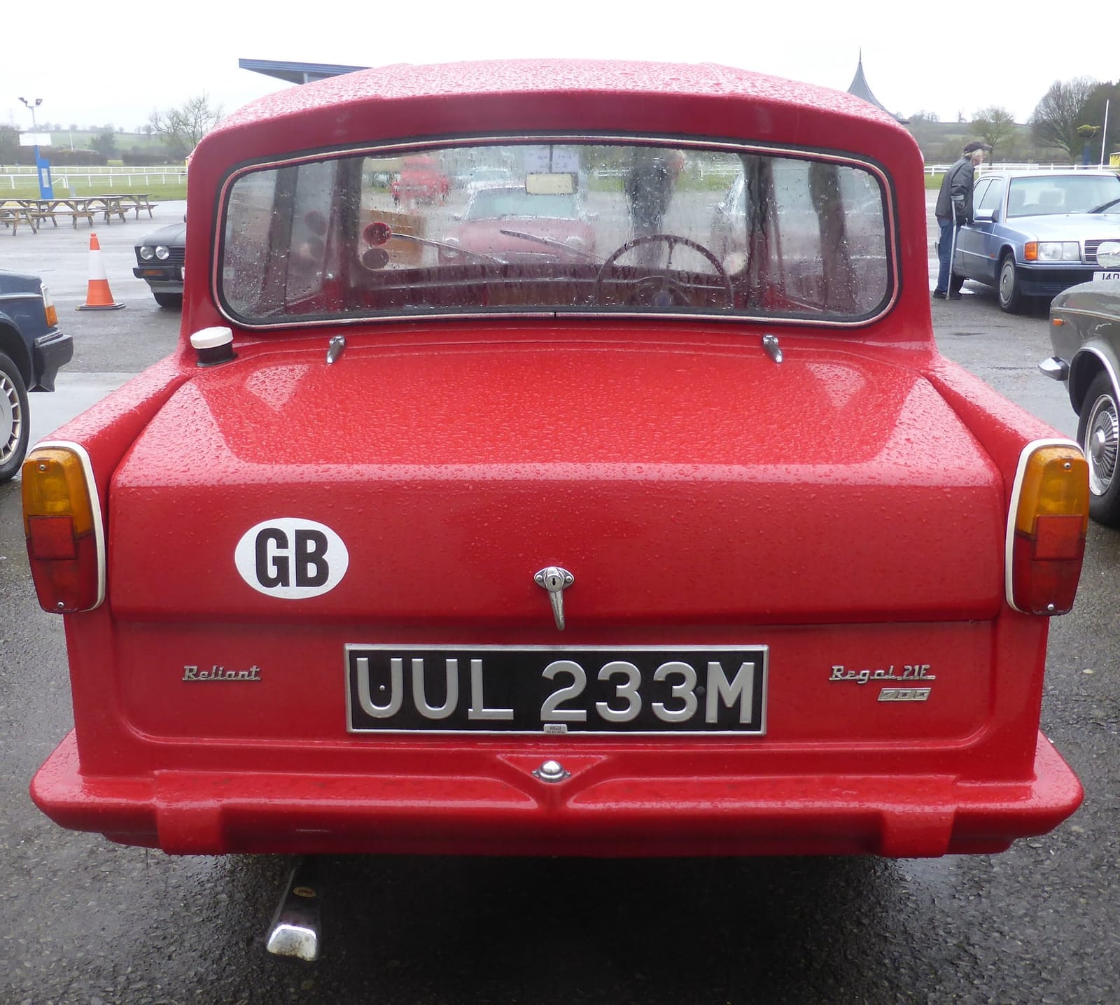 The rear of a red Reliant Regal 21E 700 showing the GB plate and Regal badging, UK registration UUL 233M