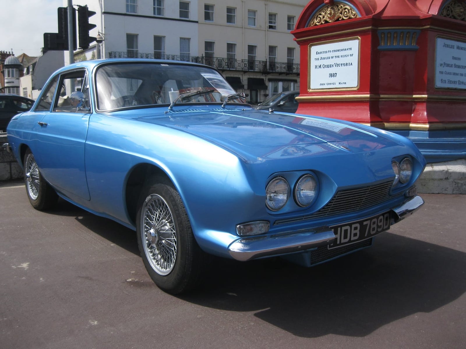A blue 1966 Reliant Scimitar GT SE4 coupe parked on a street, front three-quarter view, UK registration HDB 789C