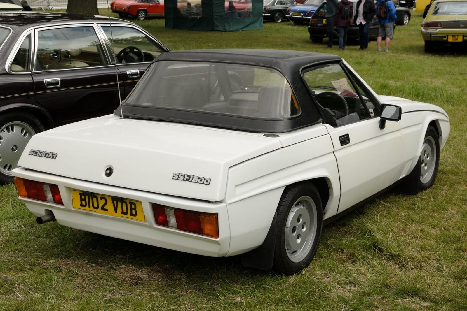 The rear three-quarter of a white 1985 Reliant Scimitar SS1 1300 with hardtop, UK registration B102 VDB