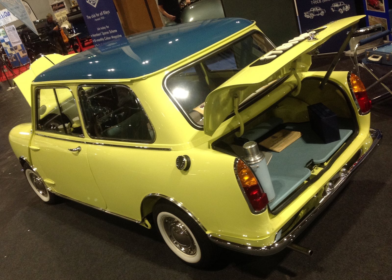 A yellow Riley Elf with the boot open, rear three-quarter view