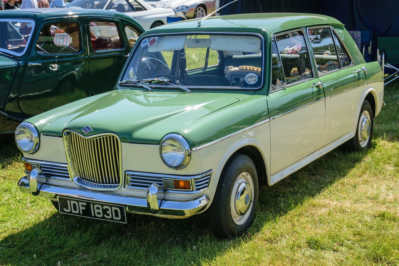 A green and white two-tone 1966 Riley Kestrel 1100 on grass at a show, UK registration JDF 183D