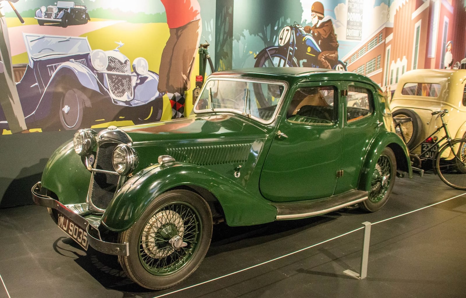 A dark green pre-war Riley Kestrel fastback saloon displayed in a museum