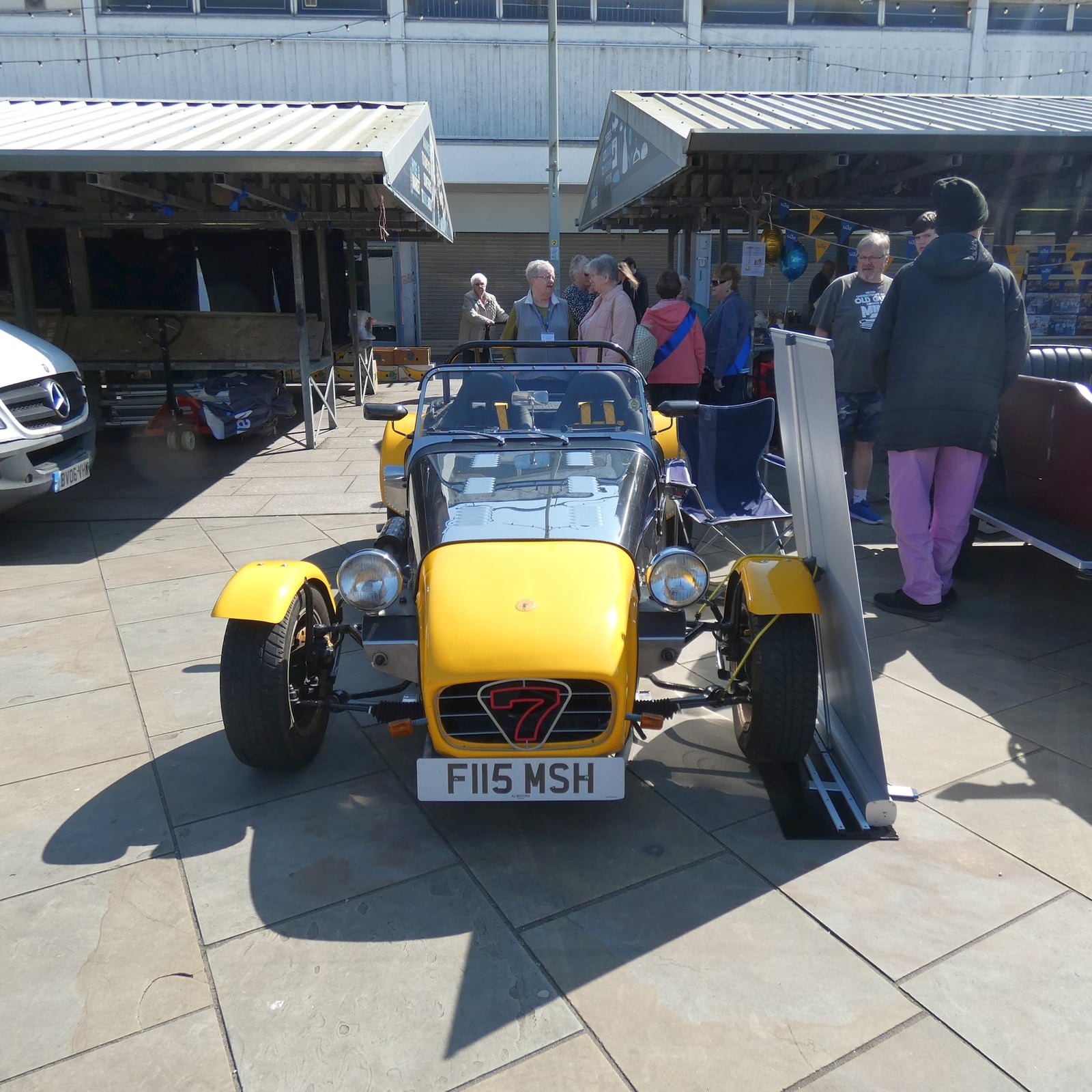 A yellow Robin Hood S7 kit car, front view, at a show