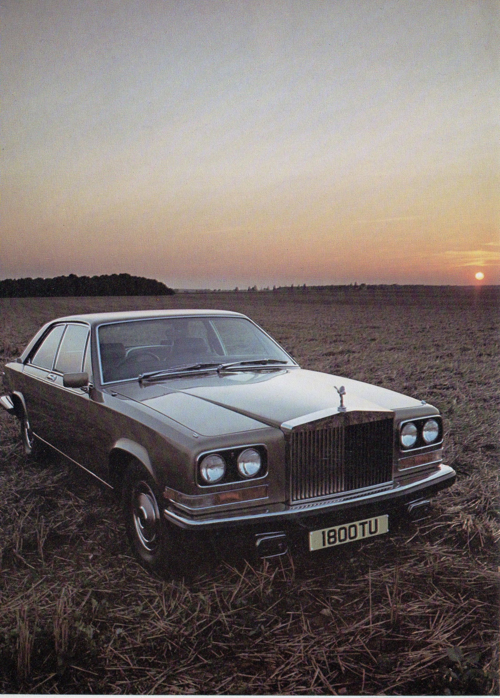 A 1977 Rolls-Royce Camargue in a field at sunset