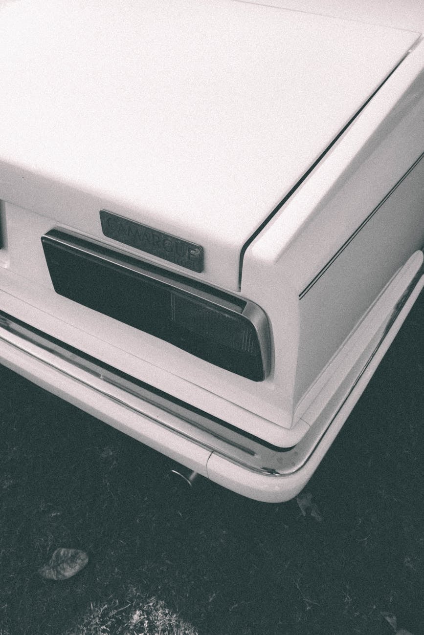 The rear quarter and tail light detail of a white Rolls-Royce Camargue