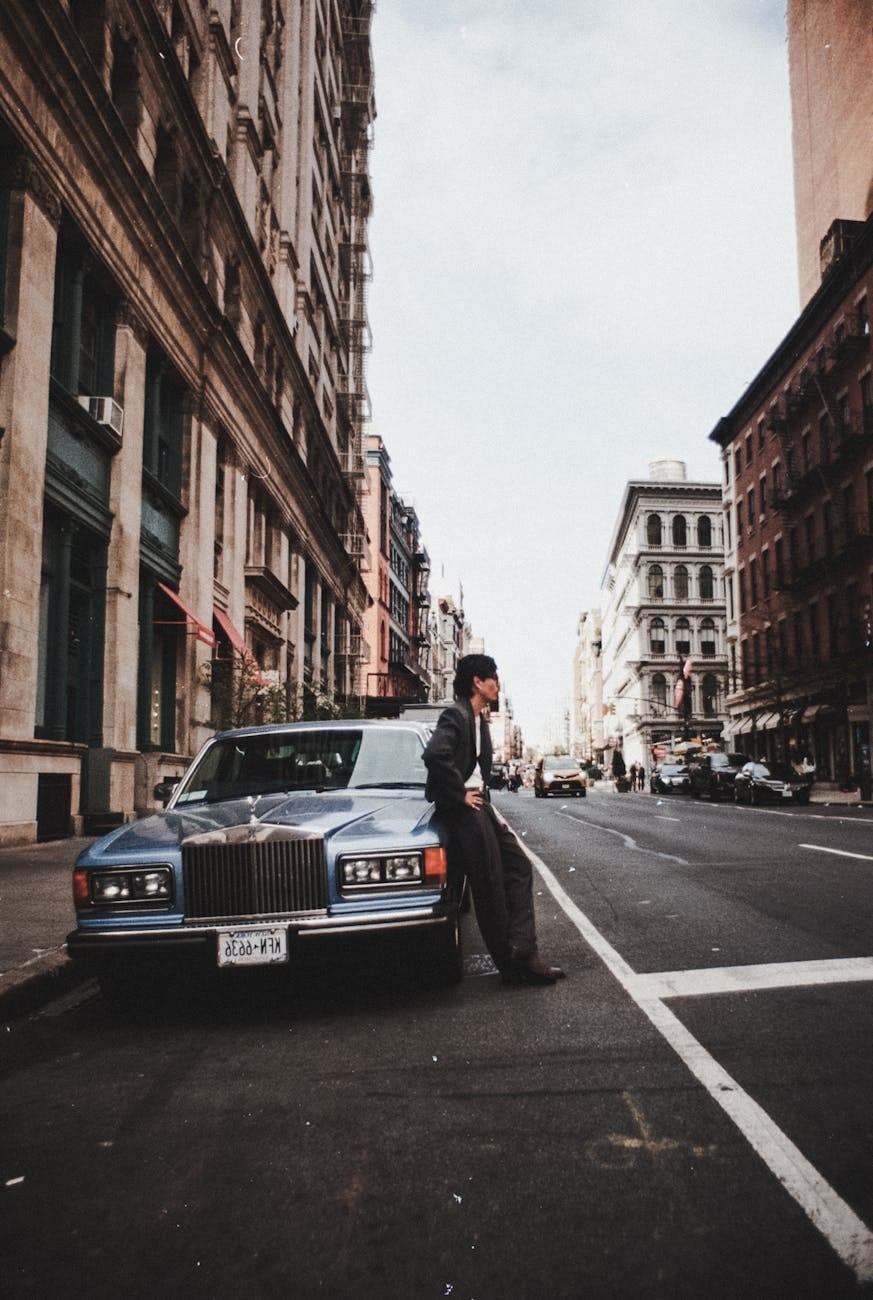 A white Rolls-Royce Silver Spirit on a New York city street with a passer-by