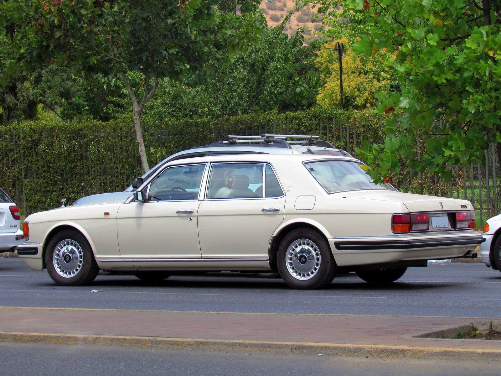 A cream Rolls-Royce Silver Spur parked on a street