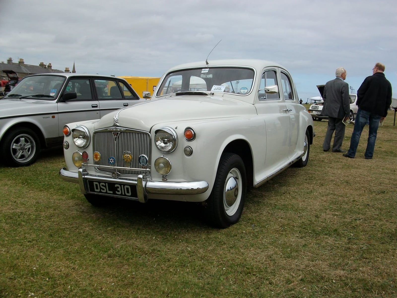 A cream Rover P4 60 on grass at a classic vehicle rally, front three-quarter view, UK registration DSL 310