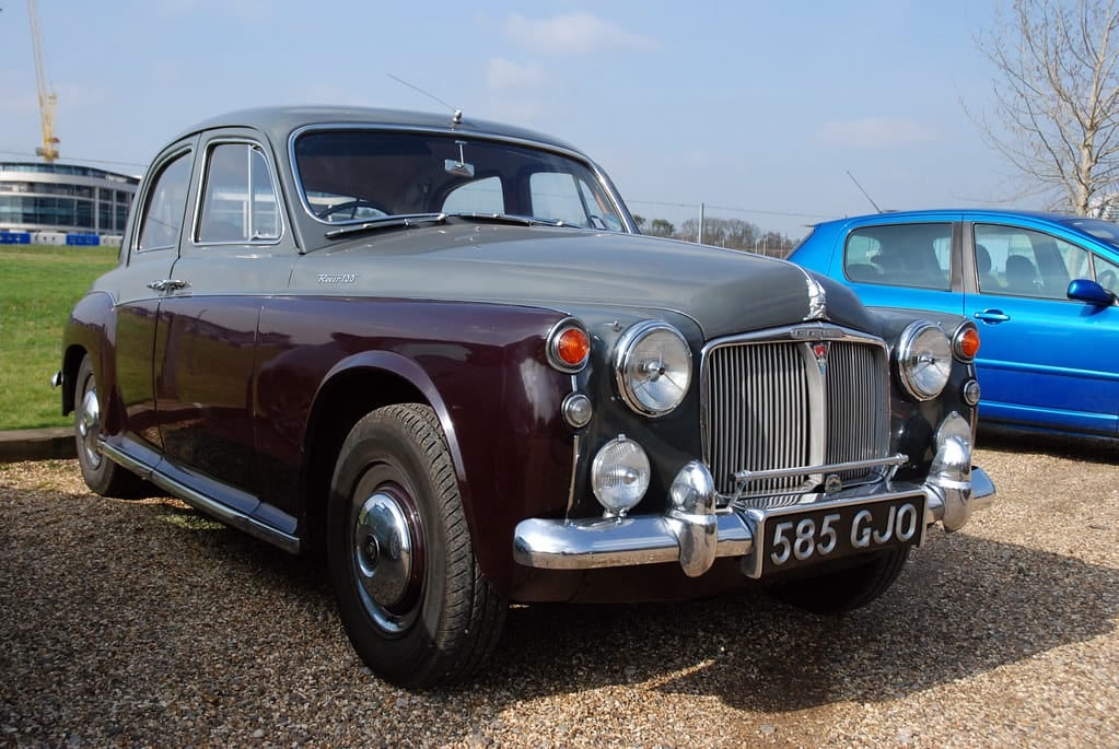 A maroon and black two-tone Rover P4 parked on gravel, front three-quarter view, UK registration 585 GJO