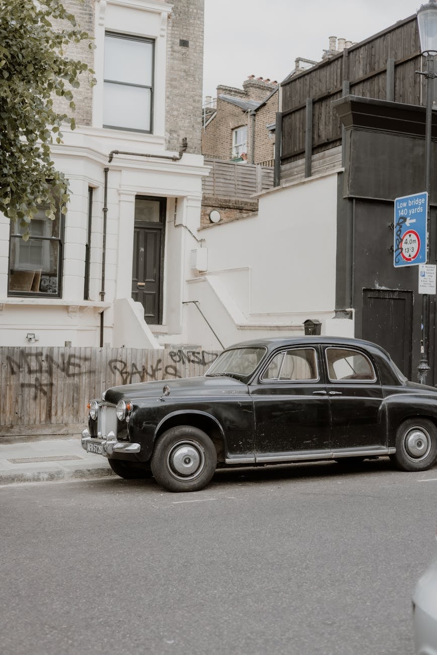 A black Rover P4 in side profile on a city street